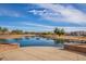 Scenic pond with fountains and landscaping; the perfect community green space to relax and enjoy the outdoors at 37161 W Giallo Ln, Maricopa, AZ 85138