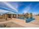 A covered picnic structure sits beside a pond in the community at 37161 W Giallo Ln, Maricopa, AZ 85138