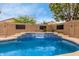 Stunning pool with cascading waterfall feature and well maintained desert landscaping at 37161 W Giallo Ln, Maricopa, AZ 85138