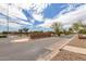 Elegant community entrance featuring the 'Sorrento' sign and well manicured desert landscaping at 37161 W Giallo Ln, Maricopa, AZ 85138