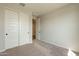 Bedroom featuring carpeted floors, sliding closet doors, and neutral paint at 39960 W Bunker Dr, Maricopa, AZ 85138