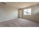 Bedroom featuring carpeted floors, a window, and neutral paint at 39960 W Bunker Dr, Maricopa, AZ 85138