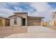 Charming single-story home with a well-maintained desert landscape and a two-car garage at 39960 W Bunker Dr, Maricopa, AZ 85138