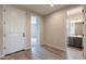 Inviting hallway with modern wood floors leading to a bathroom and other rooms at 39960 W Bunker Dr, Maricopa, AZ 85138