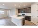 Modern kitchen with a center island featuring stainless steel appliances and ample cabinet space at 39960 W Bunker Dr, Maricopa, AZ 85138