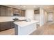 Modern kitchen featuring stainless steel appliances, gray cabinetry, and a center island at 39960 W Bunker Dr, Maricopa, AZ 85138
