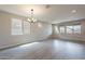 Bright and spacious living room with wood flooring, recessed lighting, and large windows at 39960 W Bunker Dr, Maricopa, AZ 85138
