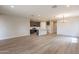 Expansive living room with wood flooring, recessed lighting, and an open layout to the kitchen at 39960 W Bunker Dr, Maricopa, AZ 85138