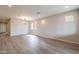 Open living room showcasing wood-look floors, recessed lighting and ample natural light from the windows at 39960 W Bunker Dr, Maricopa, AZ 85138