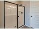 Bathroom showcasing a glass shower with black trim and brushed black accents at 39960 W Bunker Dr, Maricopa, AZ 85138