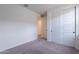 This bedroom has neutral carpet, a closet and a doorway at 40025 W Bunker Dr, Maricopa, AZ 85138
