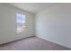 The bedroom has neutral carpet and a window at 40025 W Bunker Dr, Maricopa, AZ 85138