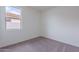 A compact bedroom with neutral carpet and a window at 40025 W Bunker Dr, Maricopa, AZ 85138