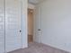 A small bedroom with neutral carpet has a doorway and a closet at 40025 W Bunker Dr, Maricopa, AZ 85138