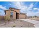 Charming single-story home featuring neutral stucco, a two-car garage, and low-maintenance desert landscaping at 40025 W Bunker Dr, Maricopa, AZ 85138