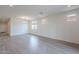 A well lit, open living room has hardwood floors and recessed lighting at 40025 W Bunker Dr, Maricopa, AZ 85138