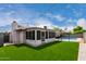 The backyard features a pool, a lawn and an enclosed sunroom at 4138 W Barbara Ave, Phoenix, AZ 85051