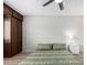 Bedroom boasts a ceiling fan and natural light from the window at 4138 W Barbara Ave, Phoenix, AZ 85051