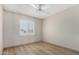 Bedroom featuring wood-look flooring, white walls, and a window with shutters at 4138 W Barbara Ave, Phoenix, AZ 85051