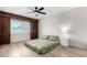Bedroom boasts a ceiling fan and natural light from the window at 4138 W Barbara Ave, Phoenix, AZ 85051
