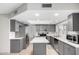 Bright kitchen features stainless appliances, gray cabinetry and an island at 4138 W Barbara Ave, Phoenix, AZ 85051