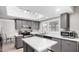 Bright kitchen features stainless appliances, gray cabinetry and an island at 4138 W Barbara Ave, Phoenix, AZ 85051