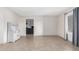 Open-concept living space with neutral walls, tile flooring, and contemporary window coverings at 4138 W Barbara Ave, Phoenix, AZ 85051
