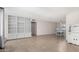 Inviting living area showcasing built-in shelves, tile flooring, and a dining area with elegant lighting at 4138 W Barbara Ave, Phoenix, AZ 85051