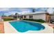 Sparkling pool and a view of the sunroom in backyard setting at 4138 W Barbara Ave, Phoenix, AZ 85051
