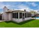 View of enclosed sunroom with outdoor access and well-kept lawn at 4138 W Barbara Ave, Phoenix, AZ 85051