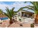 Large backyard featuring a refreshing pool, comfortable seating, and lush landscaping at 42491 W Chisholm Dr, Maricopa, AZ 85138