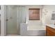 Bright bathroom featuring a soaking tub, separate shower, and modern fixtures at 42491 W Chisholm Dr, Maricopa, AZ 85138