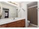 Standard bathroom with wood cabinetry, hard surface counters, and separated toilet at 42491 W Chisholm Dr, Maricopa, AZ 85138