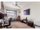 Bedroom/office with carpet, ceiling fan, view to the neighborhood, and furniture at 42491 W Chisholm Dr, Maricopa, AZ 85138