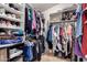 Spacious walk-in closet providing ample storage and organization solutions for clothes, shoes and accessories at 42491 W Chisholm Dr, Maricopa, AZ 85138