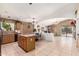 Spacious kitchen with tile flooring, an island, neutral decor, and a dining area at 42491 W Chisholm Dr, Maricopa, AZ 85138