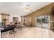 Open-concept living room featuring tile flooring, a ceiling fan and neutral decor at 42491 W Chisholm Dr, Maricopa, AZ 85138