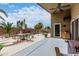 Relaxing covered patio with furniture and a view of the backyard pool and mature landscaping at 42491 W Chisholm Dr, Maricopa, AZ 85138