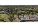 Panoramic aerial view of the community, featuring homes near a pond, park, and tennis court at 43650 W Snow Dr, Maricopa, AZ 85138