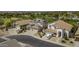 An aerial view of a neighborhood showcasing well-maintained homes with tile roofs and lush landscaping at 43650 W Snow Dr, Maricopa, AZ 85138