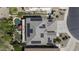 Aerial view of a home with solar panels, a pool, and lush landscaping in a residential neighborhood at 43650 W Snow Dr, Maricopa, AZ 85138
