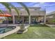 Expansive backyard featuring a pool, patio area, hot tub, seating, and artificial turf at 43650 W Snow Dr, Maricopa, AZ 85138