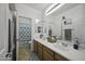 Bathroom with dual sinks, framed mirror and a shower-tub combination at 43650 W Snow Dr, Maricopa, AZ 85138