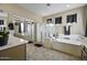 Bathroom including a tub, glass enclosed shower, and large mirrors at 43650 W Snow Dr, Maricopa, AZ 85138