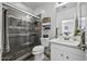 Bathroom featuring a glass-enclosed shower with gray tiling, modern fixtures, and a vanity at 43650 W Snow Dr, Maricopa, AZ 85138