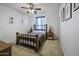 Bedroom featuring wood furnishings and matching night stands with bedside lamps at 43650 W Snow Dr, Maricopa, AZ 85138