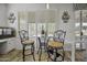 Cozy breakfast nook with a round table, barstools, and natural light from the window at 43650 W Snow Dr, Maricopa, AZ 85138