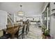 Charming dining area with a wooden table, seating for eight, and views of the kitchen and backyard at 43650 W Snow Dr, Maricopa, AZ 85138