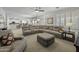 Open-concept living room with a large sectional sofa, neutral tones, and seamless flow to the kitchen at 43650 W Snow Dr, Maricopa, AZ 85138