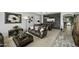Spacious living area with stylish decor, including a bar area, stone accent wall, and comfortable seating at 43650 W Snow Dr, Maricopa, AZ 85138